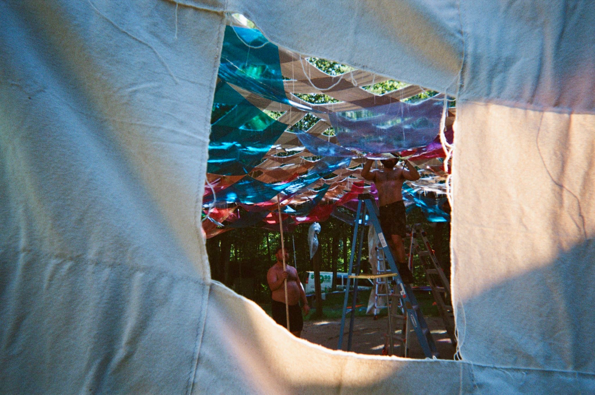 Installing the canopy, seen through an opening in the canvas web