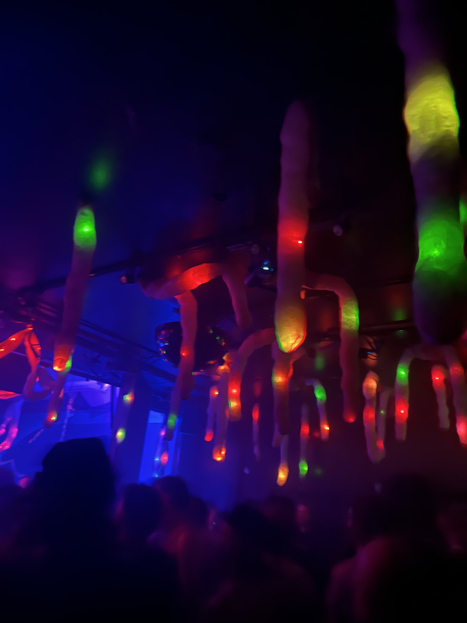 Stalactites lit red and green above the crowd