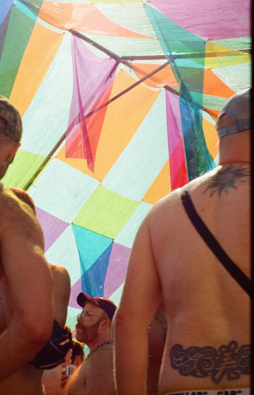 Dancers under the plaid canopy in warm afternoon light