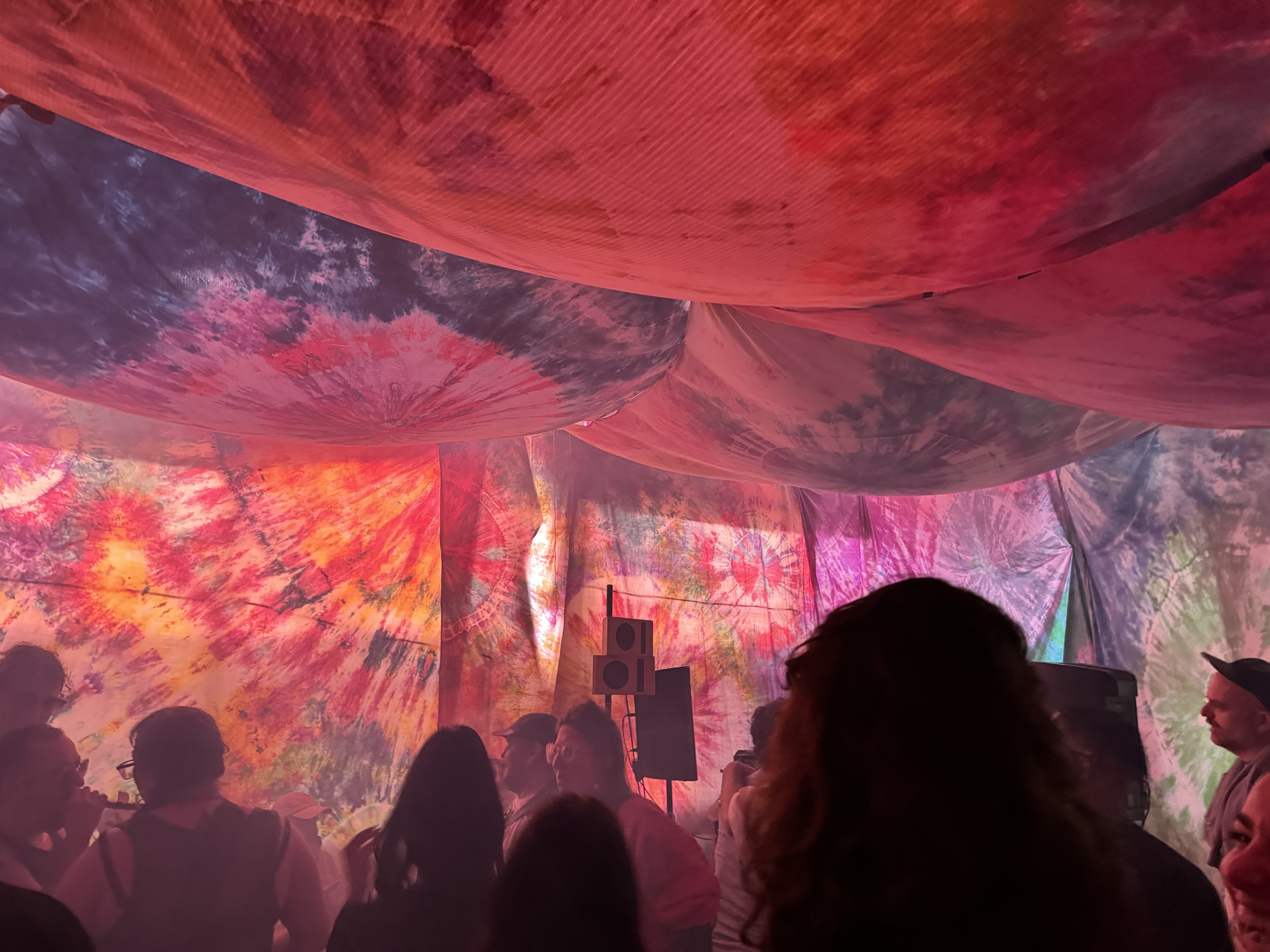 Warm red and orange light washing over the dancing crowd