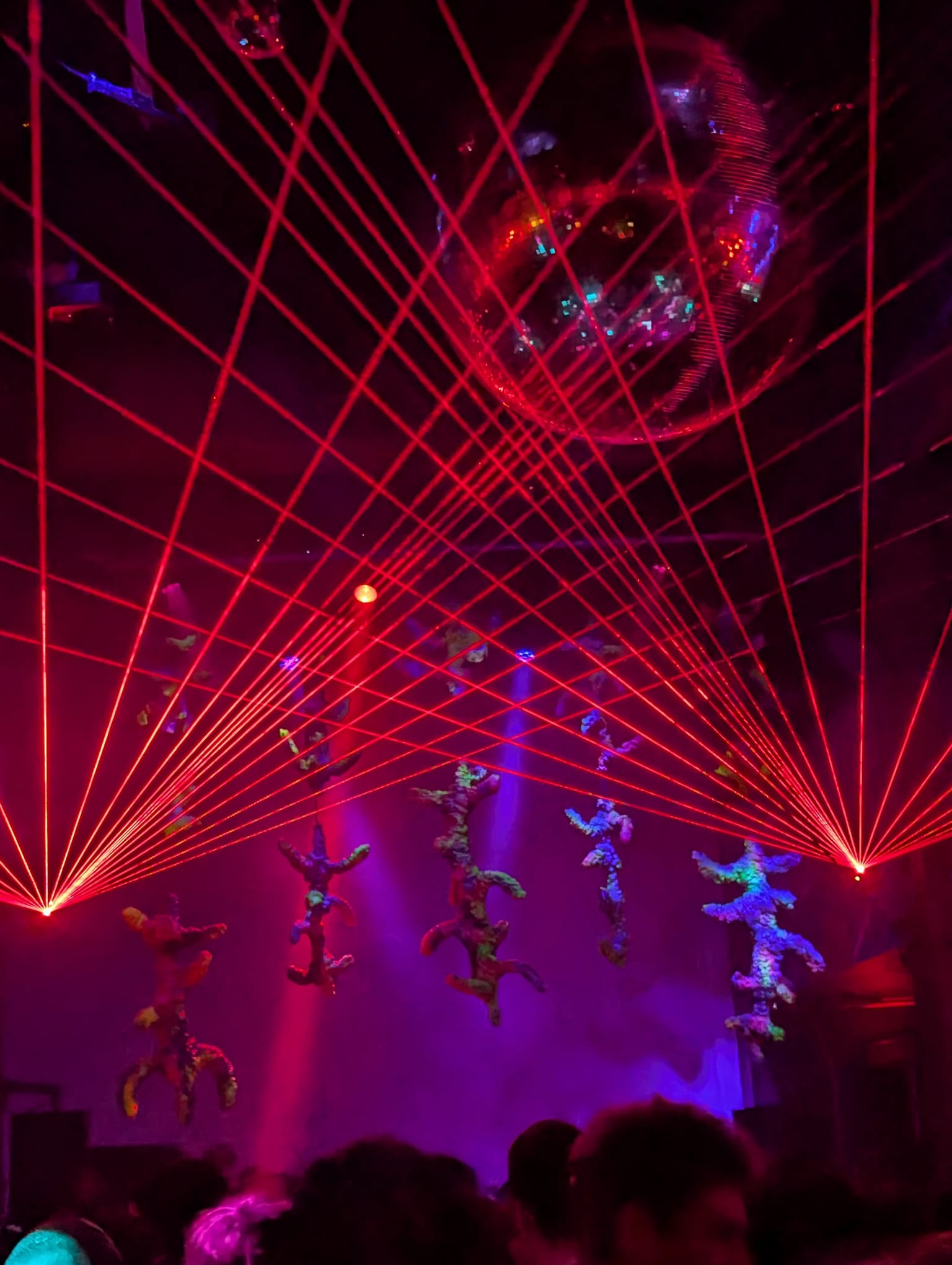 A full spread of red lasers fanning across the room